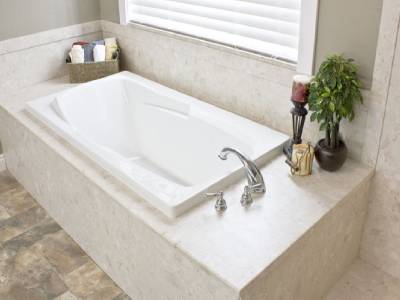 A white bathtub in a bathroom remodel with a window. - bathroom remodeling and renovation from Oasis Bath Solutions of Kent Washington