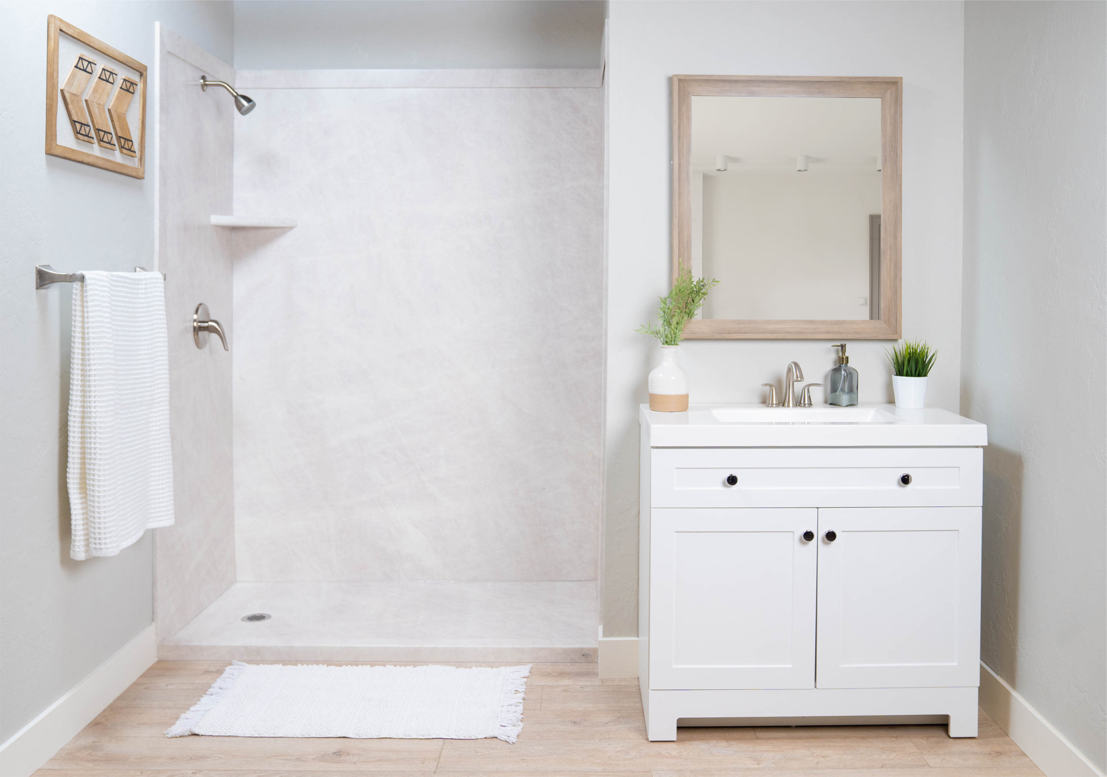 A bathroom with a white vanity and a shower stall - bathroom remodeling and renovation from Oasis Bath Solutions of Kent Washington